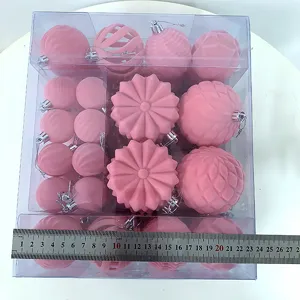 Pink flocked Christmas tree balls set in clear box, festive decorative baubles for holiday decor.