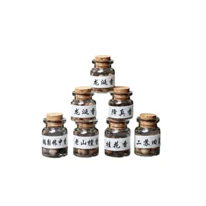 Traditional handmade aromatherapy incense pills set in glass bottles for relaxation and perfume.