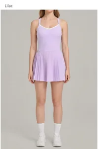 Detail view of lilac athletic tennis dress, featuring contrast trim and pleated skirt design.