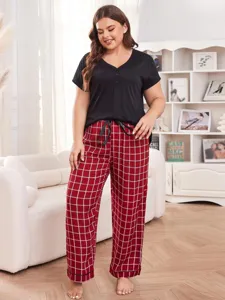 Plus size women's pajama set short sleeve top and plaid long pants for comfortable home wear.