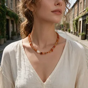 Detail shot of a vintage gemstone chip and pearl choker necklace, elegant boho collar style.