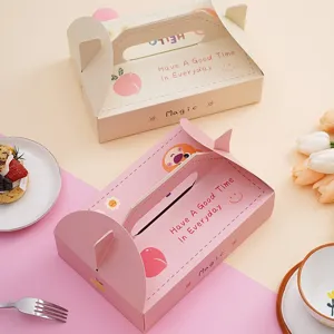 Jolies boîtes à dessert en carton rose et beige avec poignée, idéales pour macarons et gâteaux.