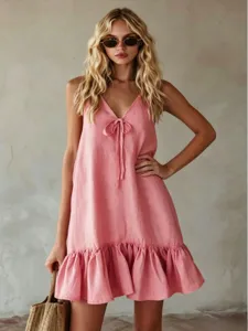 Pink sleeveless V-neck dress detail, featuring front tie and stylish ruffled hemline.