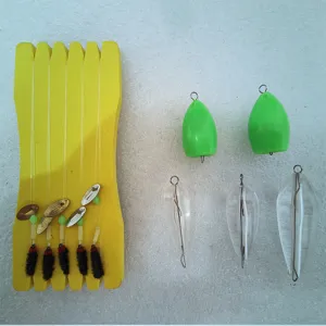 Fishing lure rig set with spoon spinners, fly hooks, line holder and transparent casting floats.