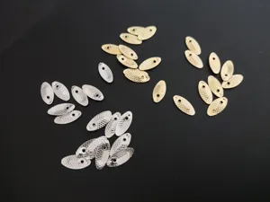 Detail shot of fish scale spinner blades for DIY fishing lures and micro fly hooks.
