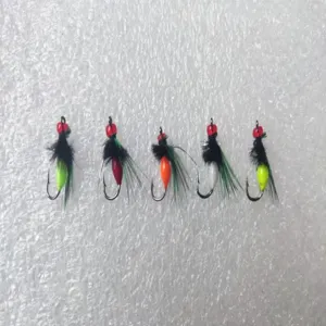 Detailed view of colorful fly fishing hooks with feather designs for outdoor fishing lovers.