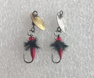 Closeup detail of fishing fly hooks set featuring metal spinner blades and feathered lures.