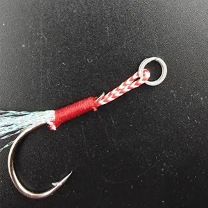 Close up of fishing assist hook with flash tinsel and split ring for slow pitch jigging.