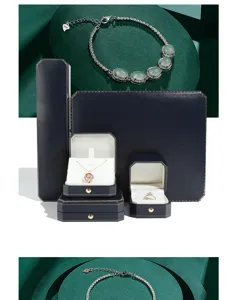 Dark blue octagonal jewelry box set with gold trim for luxury ring and necklace packaging.