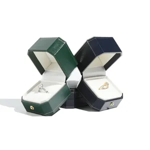 Luxury hexagonal jewelry box with gold trim, elegant gift packaging for rings and necklaces.