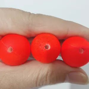 Bright orange foam fishing floats with center hole, durable strike indicators for sea fishing.