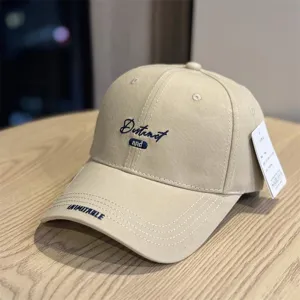 Khaki embroidered baseball cap detail showing fine stitching and classic curved brim style.