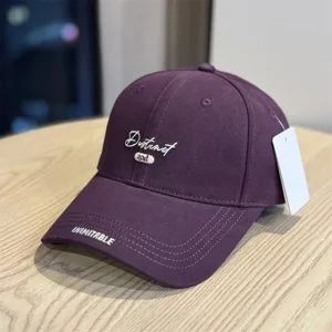 Purple embroidered baseball hat for women and men, stylish curved brim streetwear accessory.