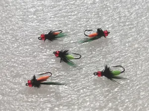 Detailed view of bionic mosquito fly fishing hooks with red beads and green tails for fishing.