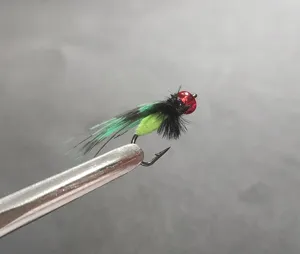 Detailed close-up of bionic fly fishing hook with red bead head and green body for lure.