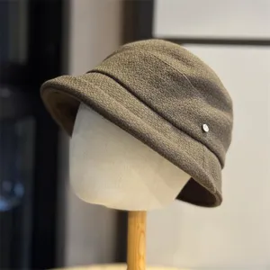 Detail shot of women's pleated bucket hat, casual brown newsboy cap for stylish everyday wear.