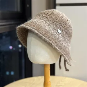 Detailed view of the stylish brown textured bucket hat with metal tag accent, cozy and warm.