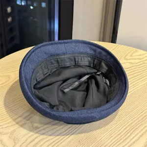 Detailed view of the dark blue denim hat interior, showing neat lining and quality craftsmanship.