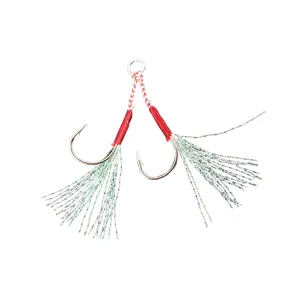 Assist fishing hooks with shiny flash tinsel and red binding for saltwater lure fishing.
