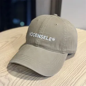 Detailed view of the casual washed cotton baseball cap with embroidered lettering and curved brim.