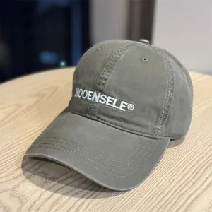Detailed view of the washed cotton baseball hat featuring white embroidered lettering.