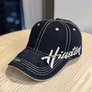 Vintage black baseball cap with white embroidered text, distressed brim and hard top for women.