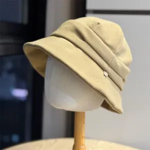 Close-up of khaki pleated bucket hat, short brim design, soft fabric, detailed craftsmanship.