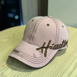 Close-up detail shot of the vintage pink baseball cap featuring stylish side embroidery.