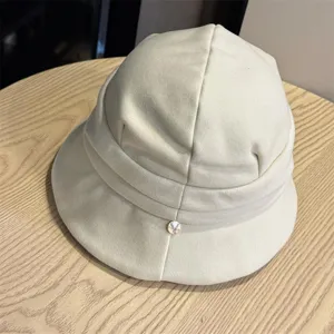 Detailed view of women casual solid color bucket hat, beige pleated design short brim cap.