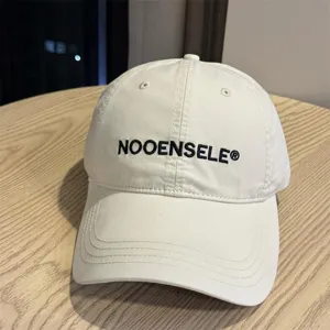 Washed cotton baseball cap with embroidered letters, curved brim, casual streetwear sun hat.