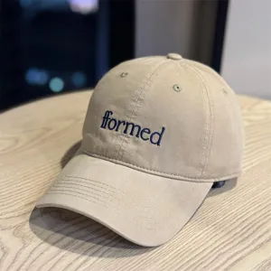 Detailed view of the khaki embroidered baseball cap with stylish blue letters for daily wear.