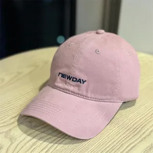 Close-up detail of the pink washed cotton baseball hat featuring neat front embroidery stitching.