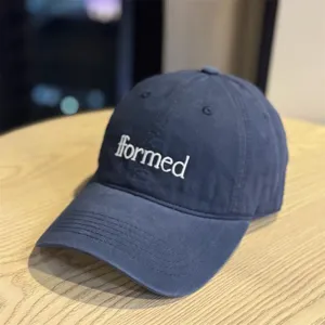 Classic navy blue baseball cap featuring stylish white embroidered lettering on the front panel.