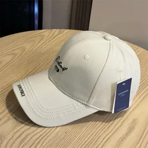 Beige embroidered baseball cap for men and women, casual curved brim street style hat.