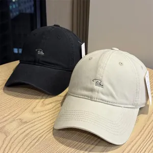 Unisex washed cotton baseball cap with stylish front embroidery, casual streetwear style.