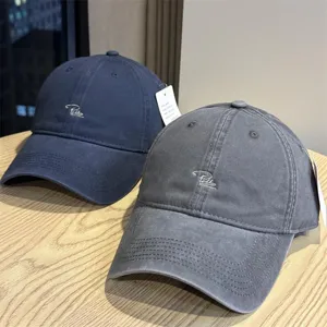 Details of washed cotton baseball cap with stylish embroidered lettering for daily wear.