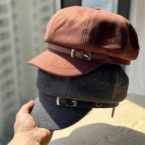 Classic wool newsboy cap with leather strap and metal buckle, stylish retro autumn winter hat.