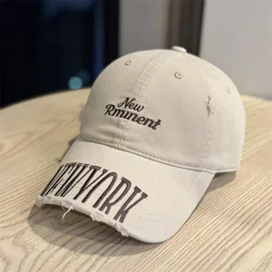 Vintage washed distressed baseball cap detail with cool embroidered letters and retro style.