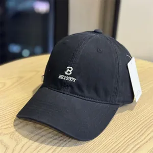 Black cotton baseball cap with embroidered letter design, casual adjustable sun hat for daily wear.
