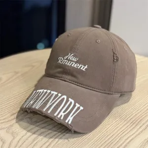Detailed view of washed brown baseball cap, featuring distressed brim and white embroidery.