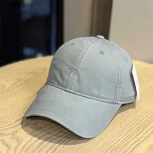 Close-up detail view of the grey washed cotton baseball cap with front embroidery.