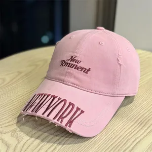 Detailed shot of the pink vintage washed distressed baseball cap with embroidered letters.