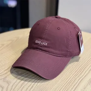 Detailed view of the vintage washed cotton baseball cap with stylish front letter embroidery.