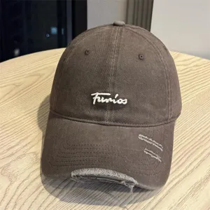 Japanese vintage style washed brown baseball cap with white embroidered letters and distressed brim.