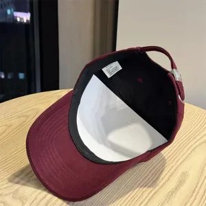 Burgundy cotton baseball cap with adjustable strap, large head circumference design for daily wear.