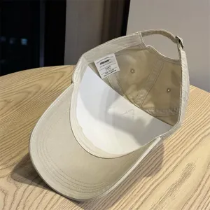 Detailed view of the vintage washed cotton baseball cap interior, inner label, and adjustable strap.