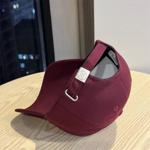 Burgundy baseball cap for men and women, classic plain dad hat with adjustable metal buckle.