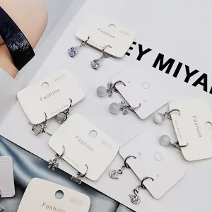 Set σκουλαρίκια από ασήμι S925 με φιόγκο, κρυστάλλινο κύκνο και πέτρα μάτι γάτας.