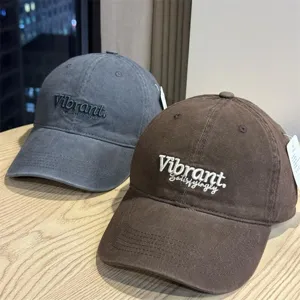 Washed cotton baseball cap for women with deep crown, wide brim, embroidered letter design.