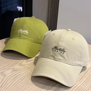 Detailed view of casual washed cotton baseball cap with embroidered logo, soft top design.